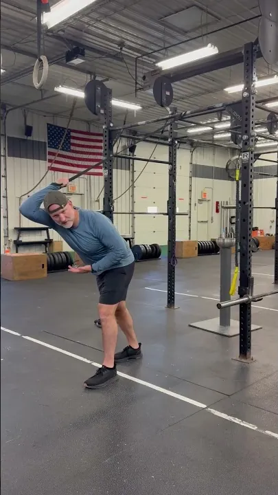 Band shoulder mobility routine demonstrated in the gym